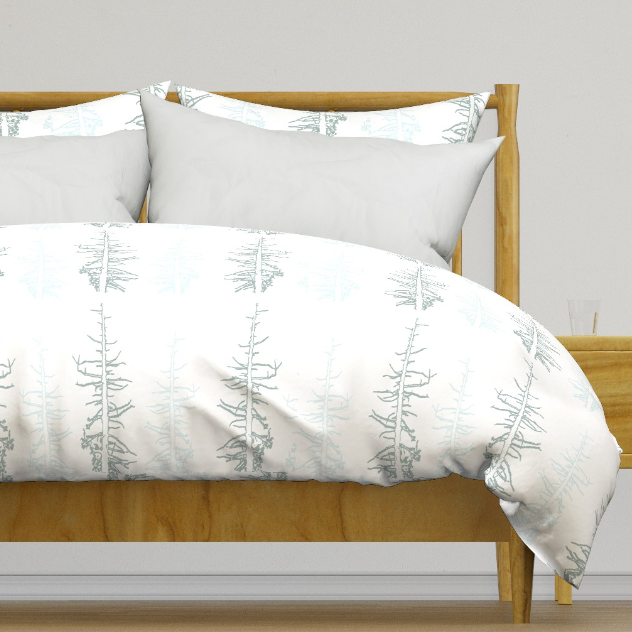 Pines against the snow duvet cover